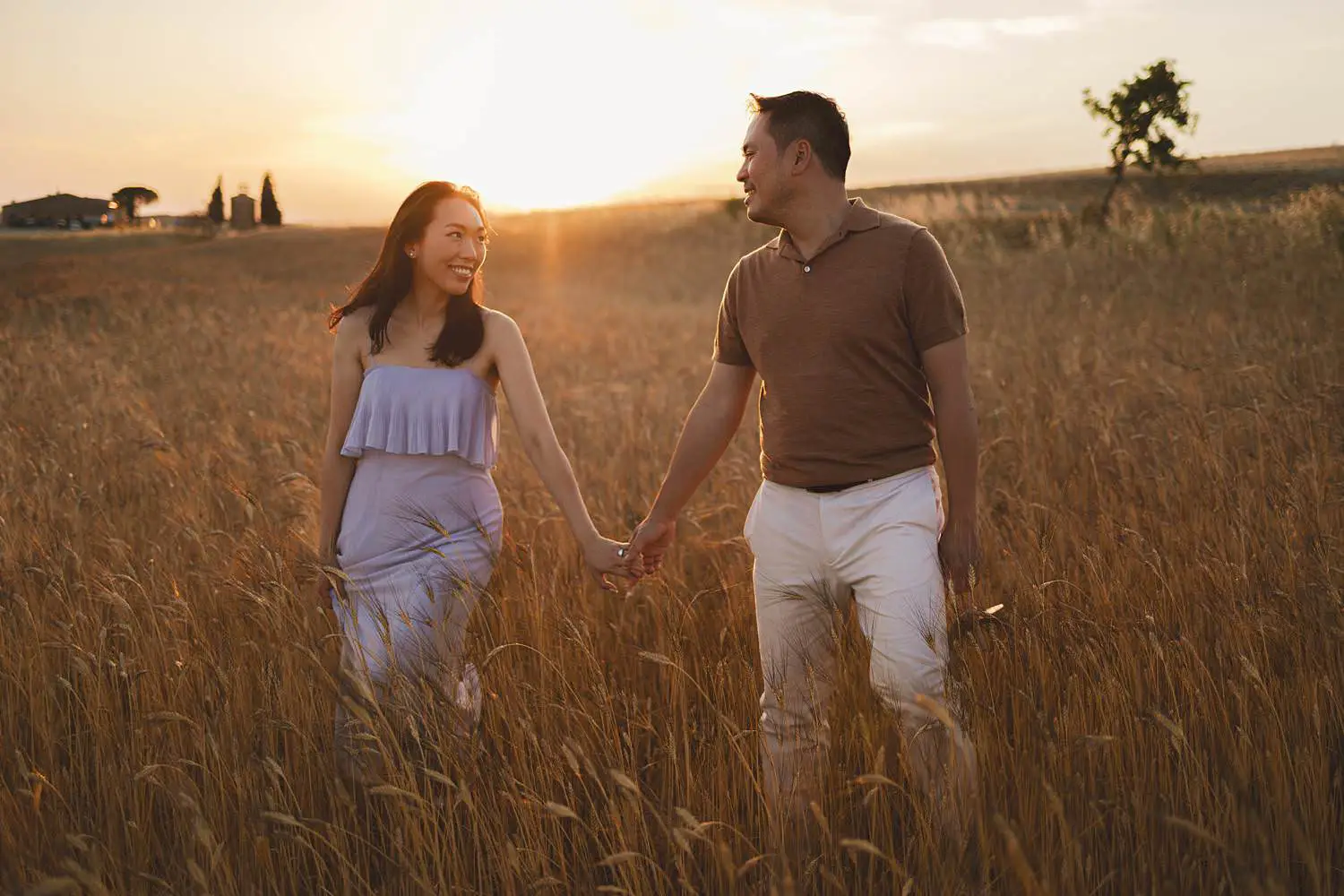 Exciting couple photo shoot under warm golden light near Vitaleta Chapel