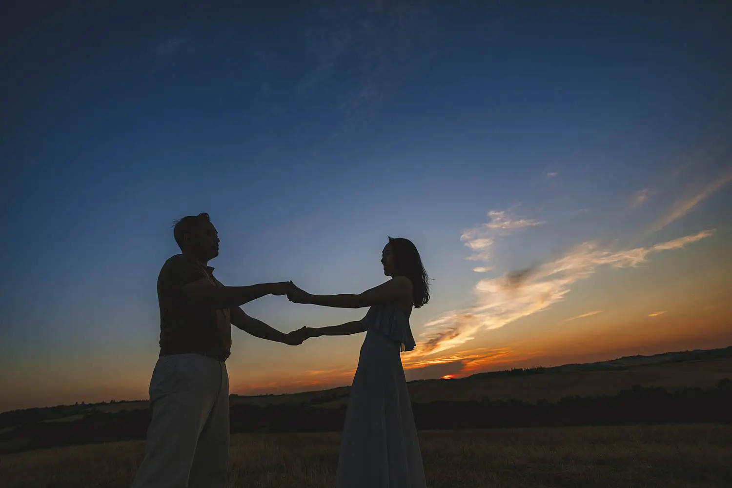 Joyful engagement photo session between Pienza and the Iconic Chapel of Vitaleta at sunset
