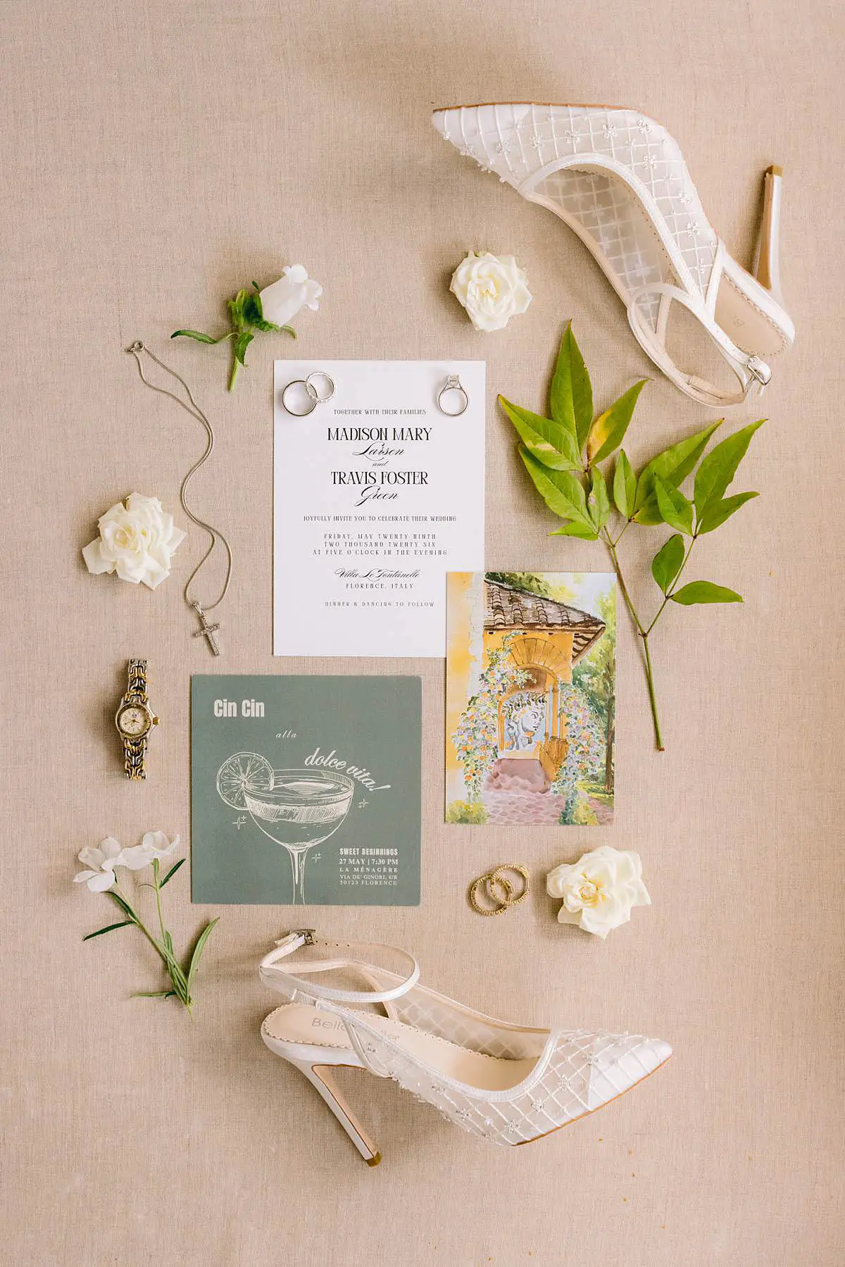 Wedding invitation, rings, shoes, flowers and bridal accessories arranged for a Villa Le Fontanelle wedding in Tuscany.