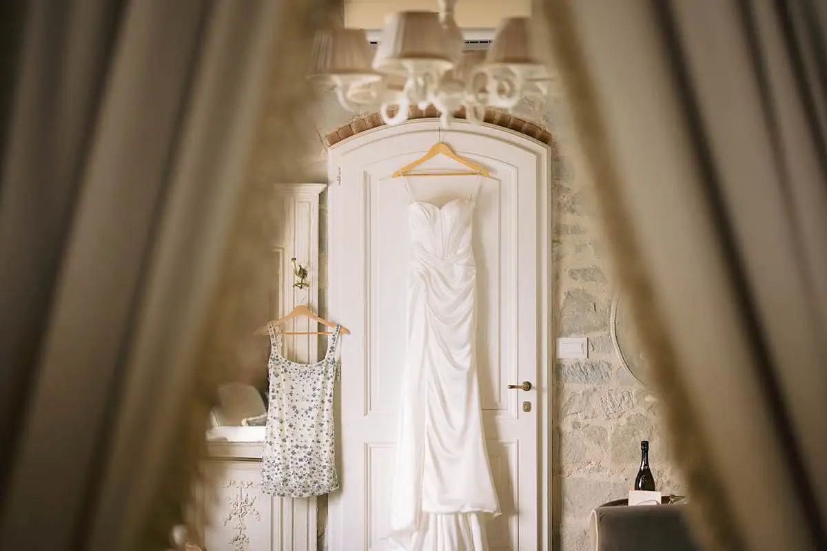 White wedding dress hanging in an ornate suite at Villa Le Fontanelle.
