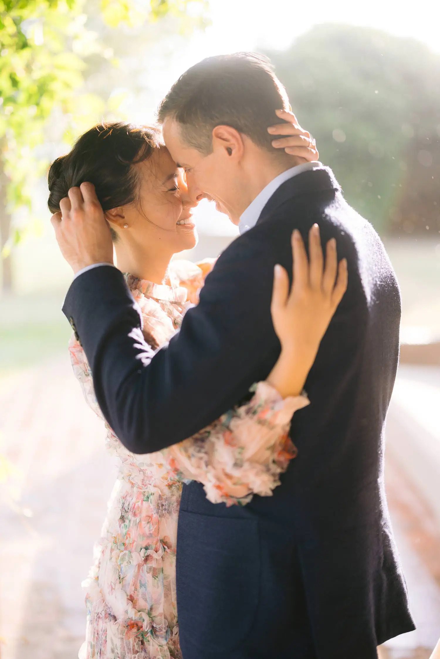 An intimate couple portrait in soft light at Capanna House, with one partner gently cradling the other’s face.