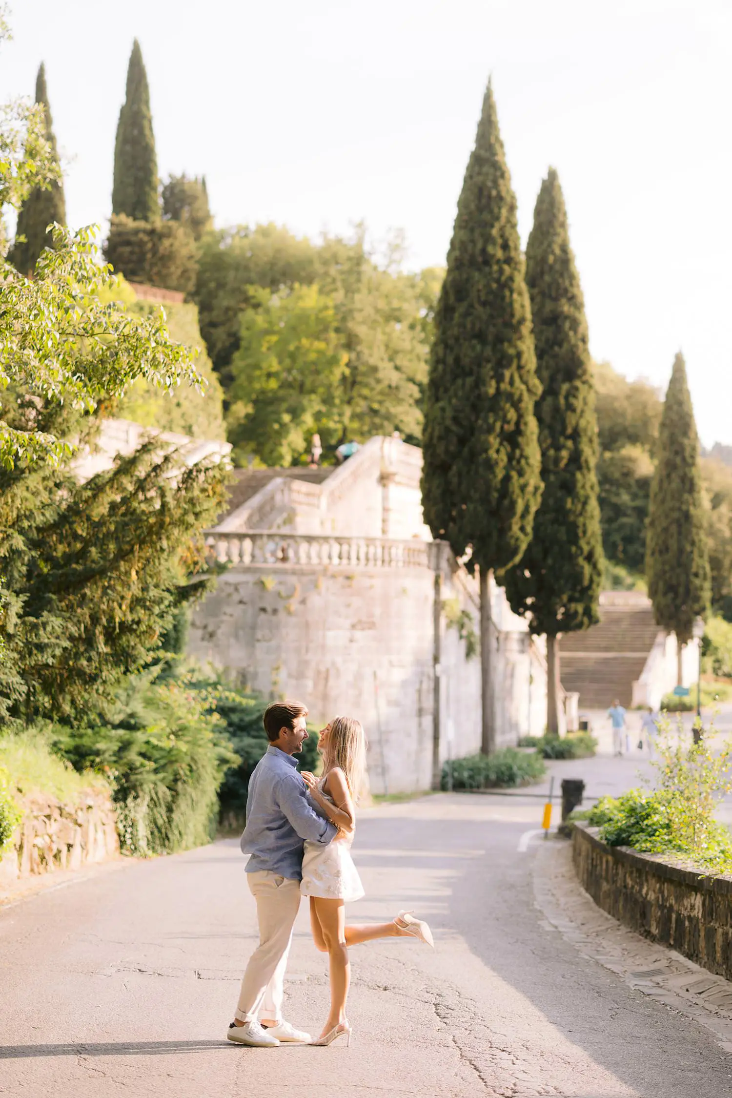 Couple embracing on a cypress-lined road near San Miniato al Monte in Florence.
