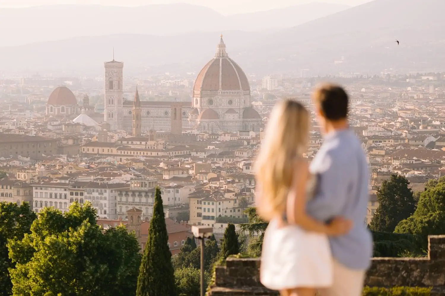 Couple overlooking Florence Cathedral from San Miniato al Monte during a pre-wedding photoshoot.