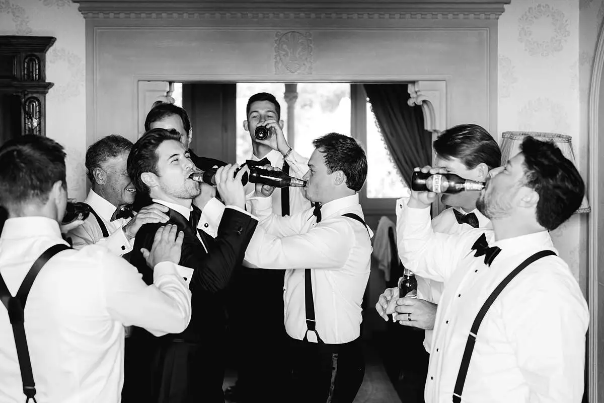 Groomsmen in tuxedos share a celebratory toast before the Villa Le Fontanelle wedding.