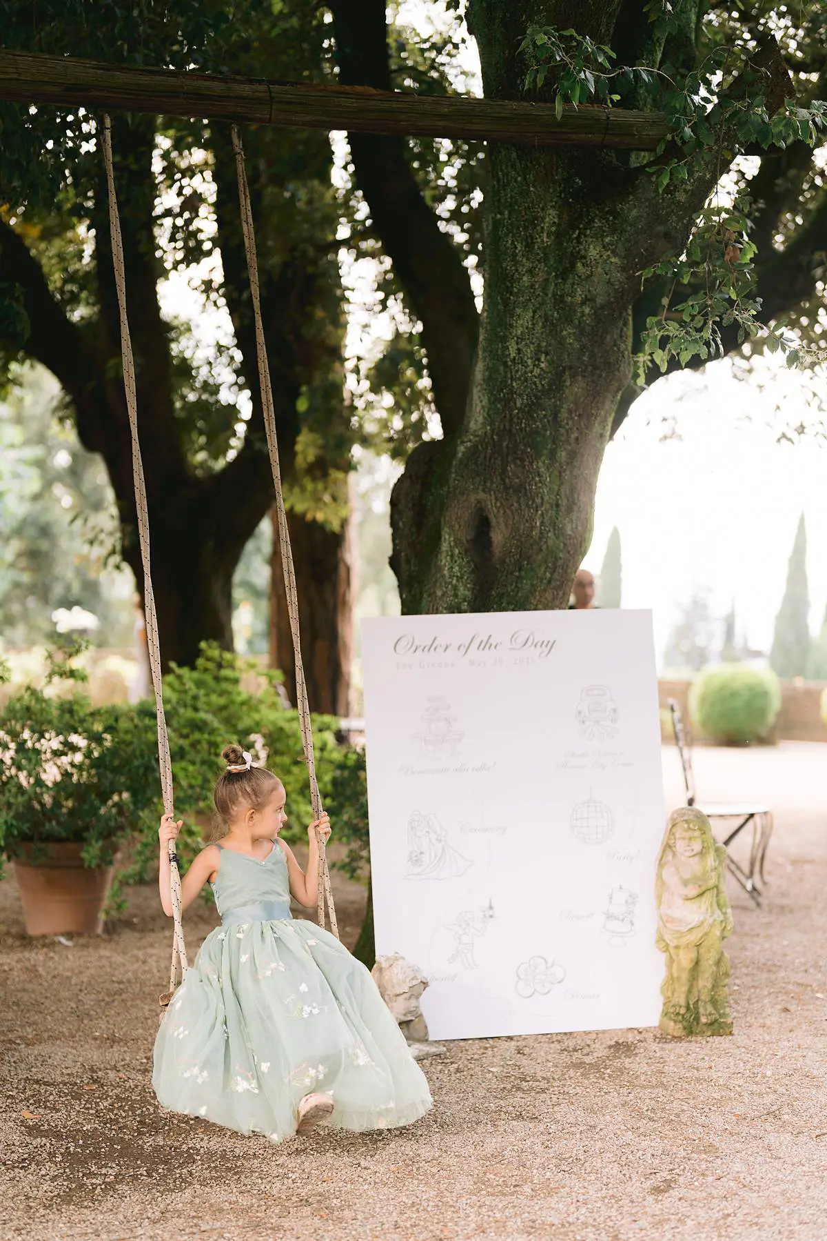 Floral girl beside a welcome sign at Villa Le Fontanelle.
