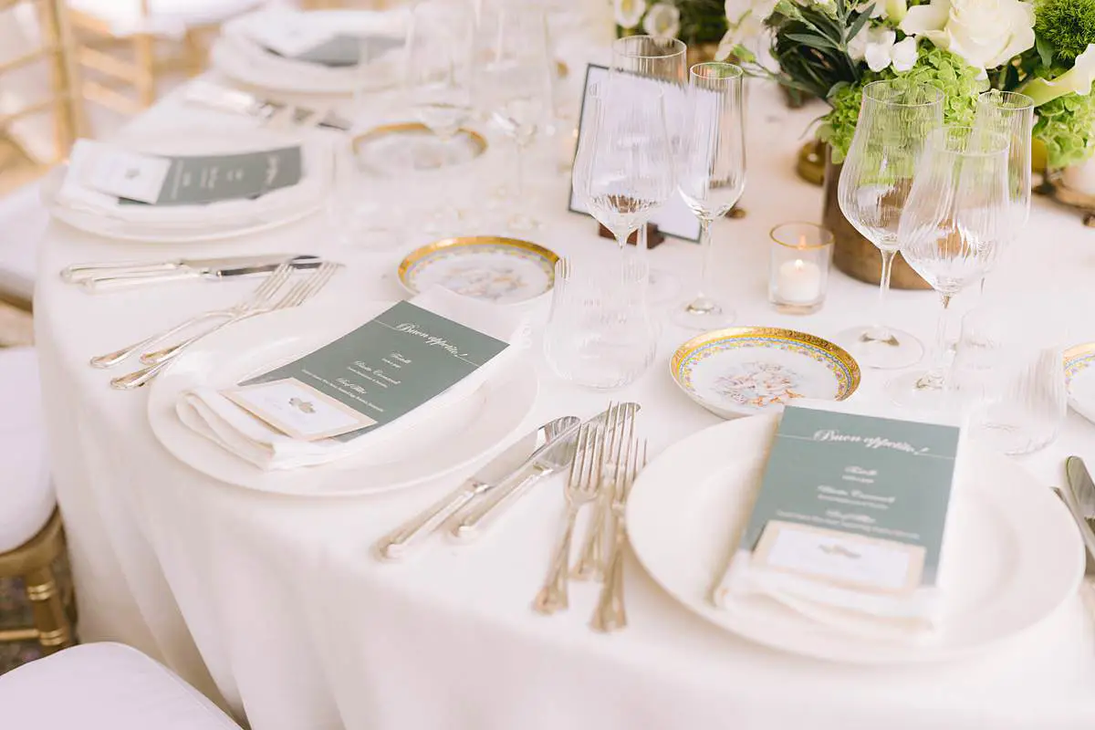 Wedding reception table set with menus, flowers and candles at Villa Le Fontanelle.