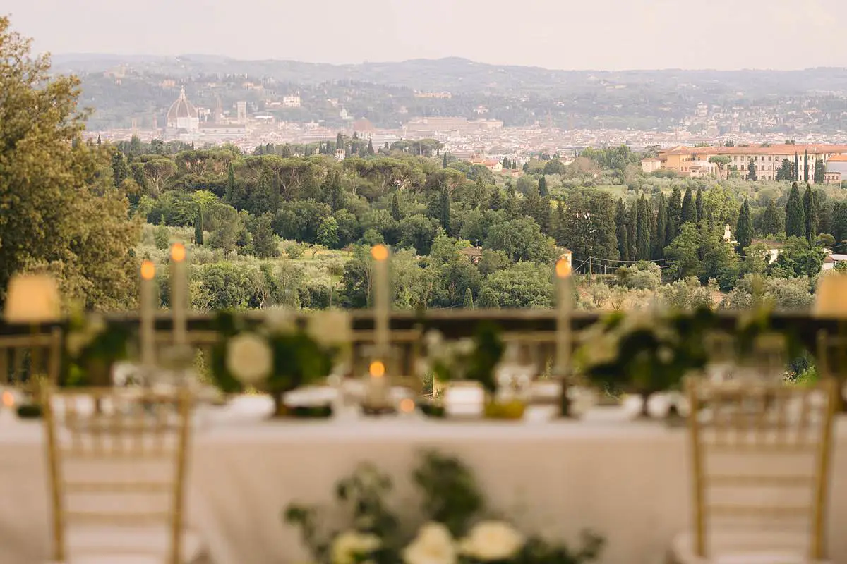 Outdoor wedding reception tables overlook Florence from Villa Le Fontanelle.
