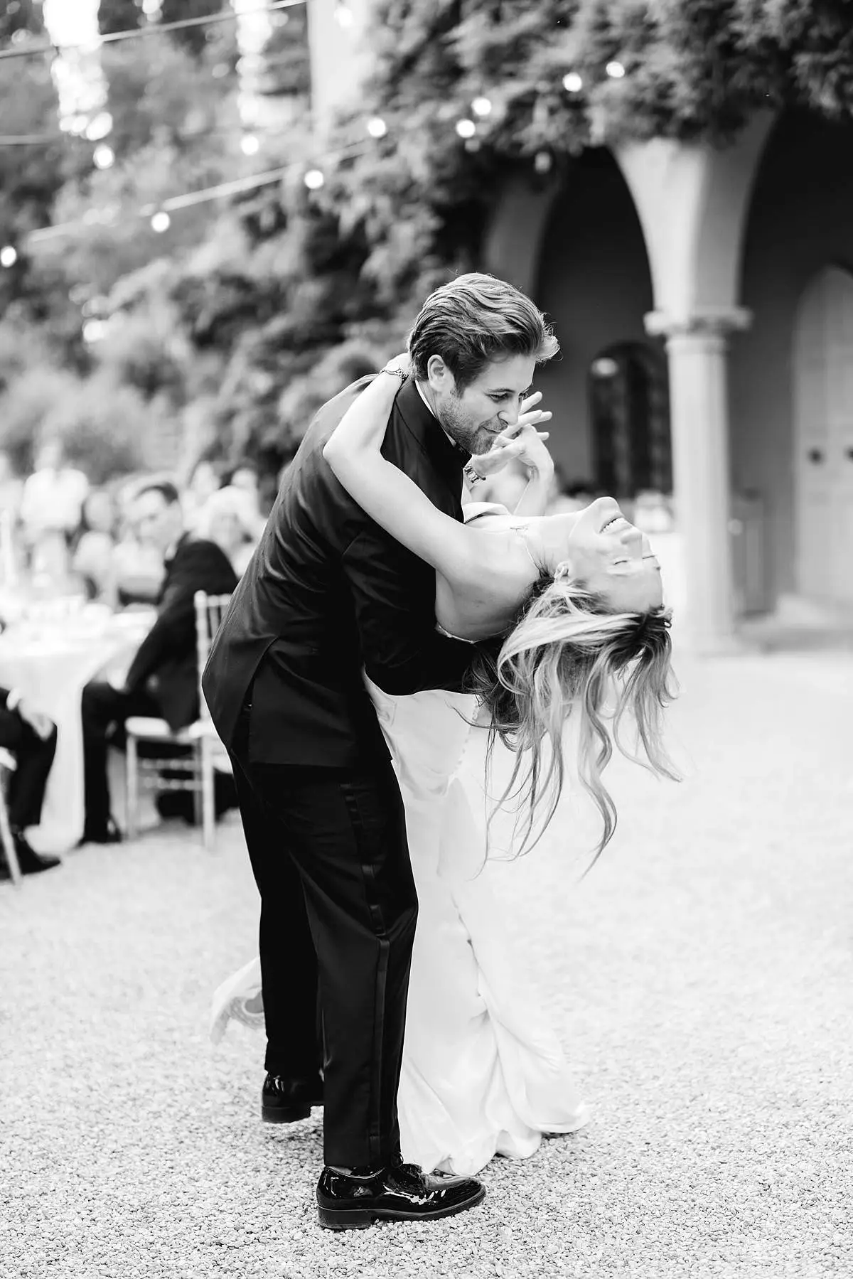 Travis dips Madison during their outdoor wedding reception at Villa Le Fontanelle.